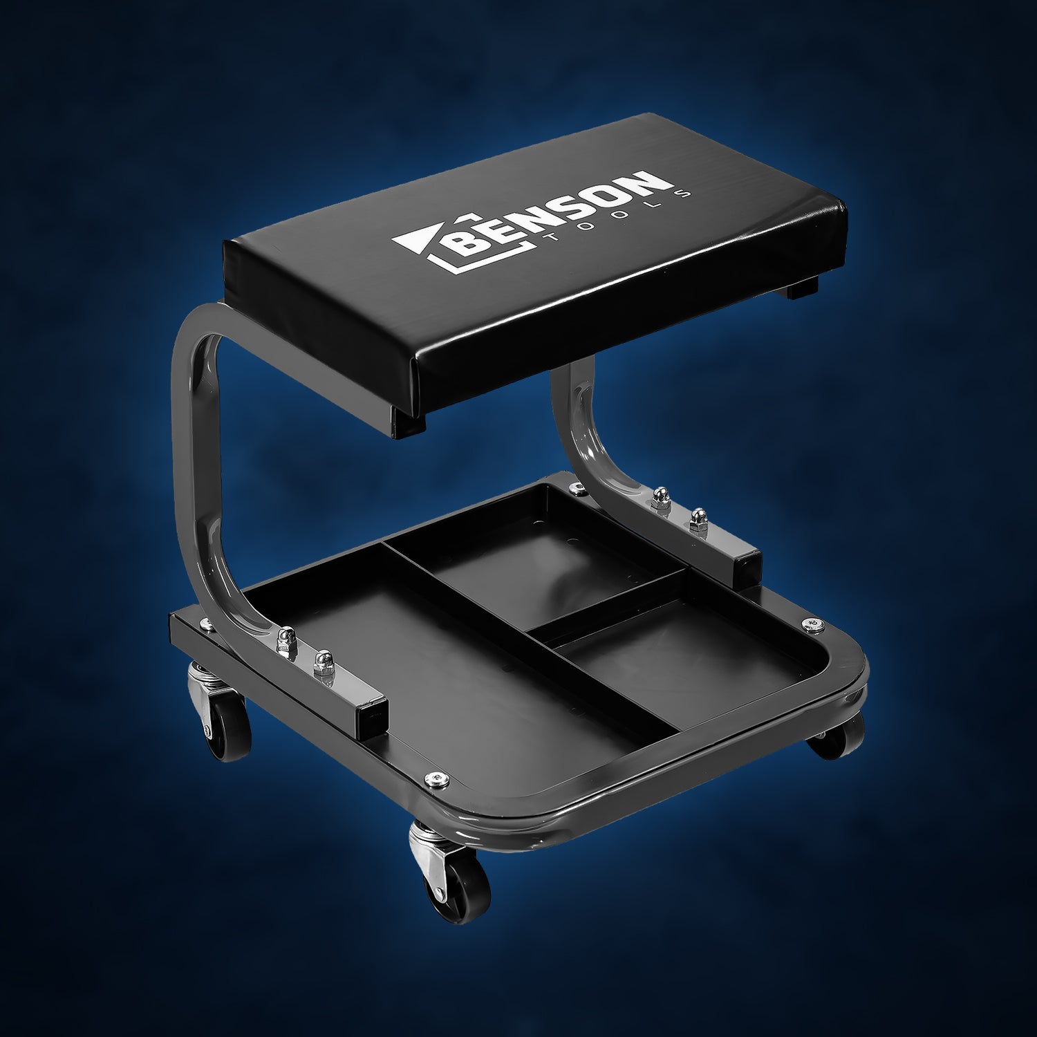 Niedriger, rollbarer Werkstatthocker mit schwarzer gepolsterter Sitzfläche, gebogenem Metallrahmen und unterteilter Ablagefläche auf vier kleinen Lenkrollen.